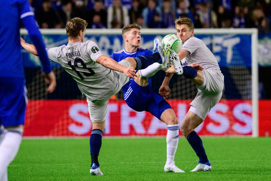 Hampus Finndell and Rasmus Schüller of Djurgården against Markus André Kaasa of Molde