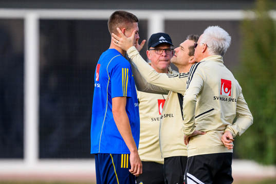 Emil Holm of the Swedish national football team is looked