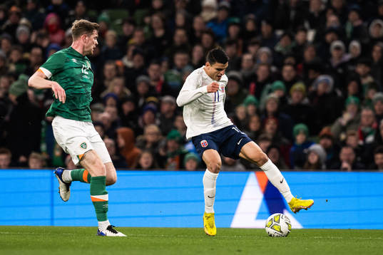 Nathan Collins of Ireland and goalkeeper Mads Hedenstad Christiansen of Norway