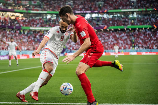 Issam Jebali of Tunisia and Andreas Christensen of Denmark