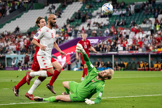 Issam Jebali of Tunisia and goalkeeper Kasper Schmeichel of
