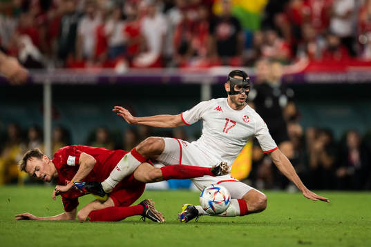 Mikkel Damsgaard of Denmark and Ellyes Skhiri of Tunisia