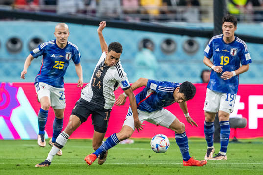 Jamal Musiala of Germany and Wataru Endo of Japan