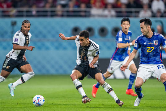 Jamal Musiala of Germany and Maya Yoshida of Japan