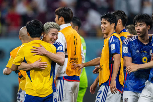 Takuma Asano of Japan celebrates with team mates