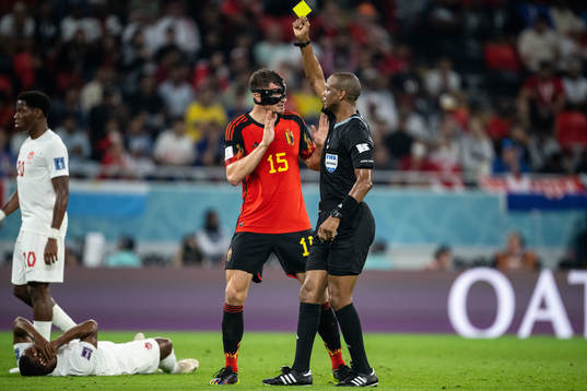 Thomas Meunier of Belgium receives a yellow card from referee Janny Sikazwe