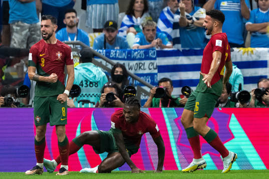 Bruno Fernandes of Portugal celebrates with Rafael Leao and Goncalo Ramos after 2-0 on a penalty