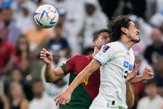 Ruben Dias of Portugal and Edinson Cavani of Uruguay