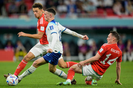 Ethan Ampadu and Connor Roberts of Wales against Phil Foden of England