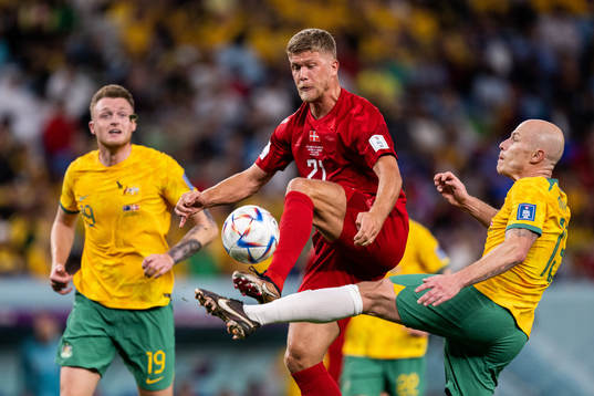 Andreas Cornelius of Denmark against Harry Souttar and Rasmus Kristensen of Australia