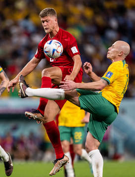 Andreas Cornelius of Denmark against Harry Souttar and Rasmus Kristensen of Australia