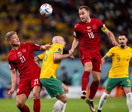 Andreas Cornelius and Christian Eriksen of Denmark against Aaron Mooy of Australia