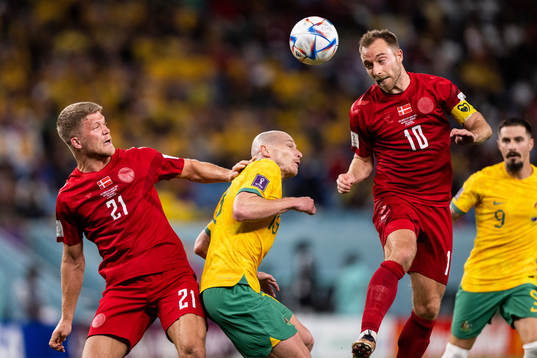 Andreas Cornelius and Christian Eriksen of Denmark against Aaron Mooy of Australia