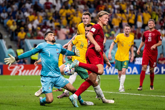 Goalkeeper Mathew Ryan of Australia makes a save against Kasper Dolberg of Denmark