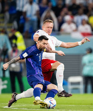 Lionel Messi of Argentina and Kamil Glik of Poland