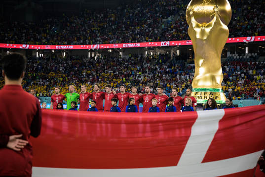 Christian Eriksen, goalkeeper Kasper Schmeichel, Rasmus Kristensen, Joachim Andersen, Andreas Skov Olsen, Andreas Christensen, Jesper Lindstrøm, Pierre-Emile Højbjerg, Joakim Mæhle, Mathias Jensen and Martin Braithwaite of Denmark sing the national anthem ahead of the FIFA World Cup 2022 football match between Australia and Denmark on November 30, 2022 in Doha. 