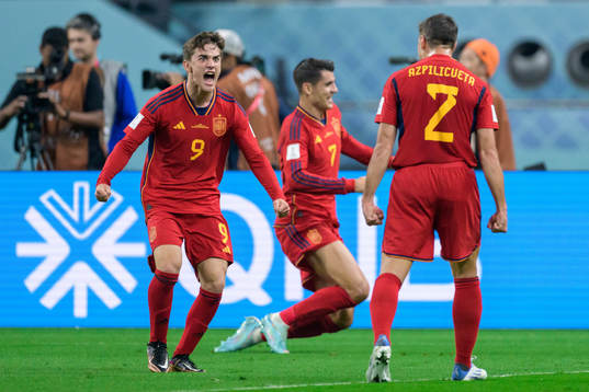Gavi, Alvaro Morata and Cesar Azpilicueta of Spain celebrate after scoring 0-1