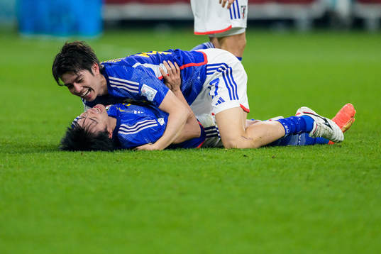 Kaoru Mitoma and Ao Tanaka of Japan celebrate