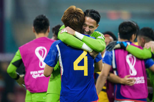 Kou Itakura and goalkeeper Eiji Kawashima of Japan celebrate