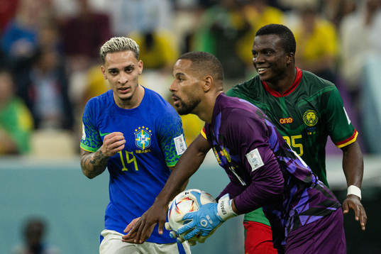 Antony of Brazil against goalkeeper Devis Epassy and Nouhou Tolo of Cameroon