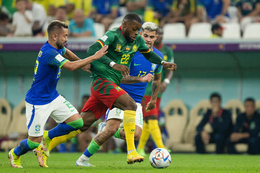 Olivier Ntcham of Cameroon against Danilo and Bruno Guimaraes of Brazil