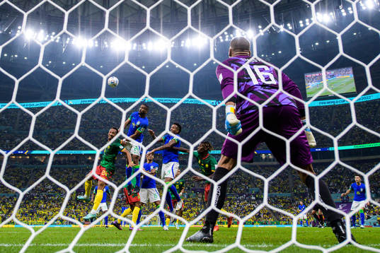 Goalkeeper Devis Epassy of Cameroon see Bremer and Eder Militao of Brazil challenge Enzo Ebosse and Christopher Wooh of Cameroon
