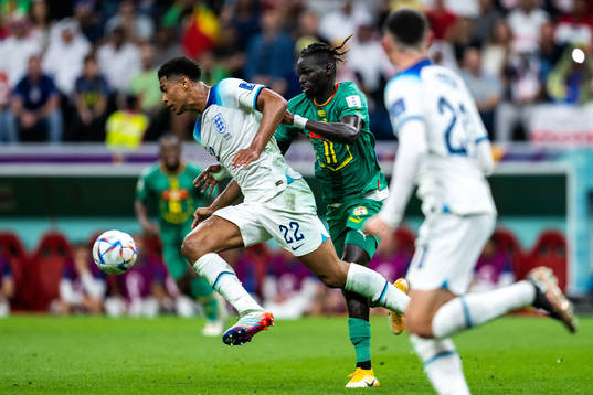 Jude Bellingham of England and Pathe Ciss of Senegal