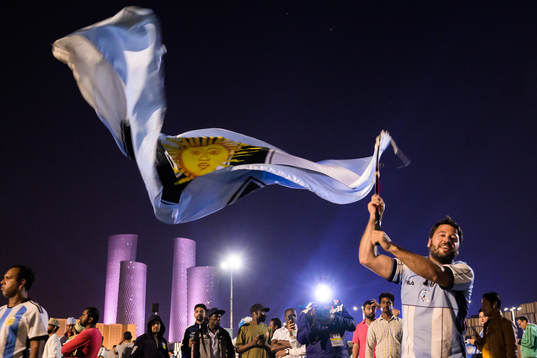 A man with a Diego Maradona jersey waves a modified Argentinian flag ahead of the FIFA World Cup 2022 semifinal between Argentina and Croatia on December 13, 2022 in Doha. 