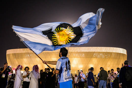 A man with a Diego Maradona jersey waves a modified Argentinian flag in front of Lusail Stadium ahead of the FIFA World Cup 2022 semifinal between Argentina and Croatia on December 13, 2022 in Doha. 