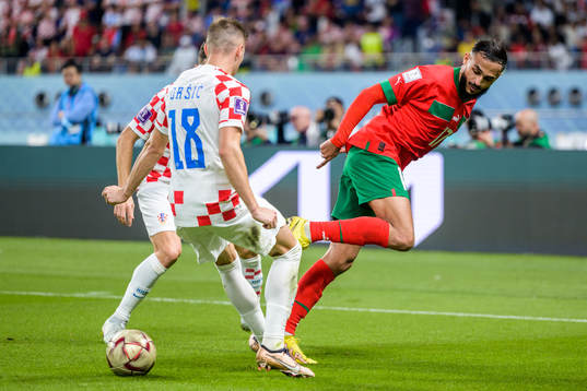 Ivan Perisic and Mislav Orsic of Croatia against Sofiane Boufal of Morocco
