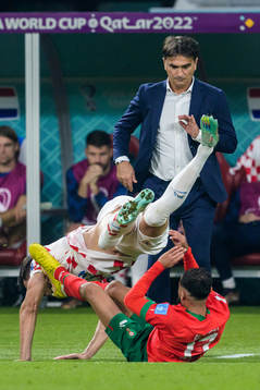 Josip Sutalo of Croatia and Sofiane Boufal of Morocco infront of head coach Zlatko Dalic of Croatia