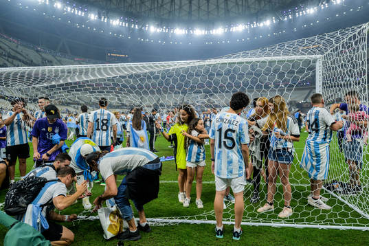 Family members of the Argentinian players cut the net of