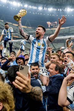 Lionel Messi of Argentina celebrates with the FIFA World Cup Trophy