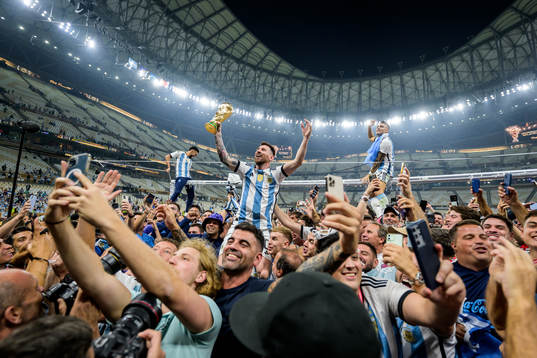 Lionel Messi of Argentina celebrates with the FIFA World Cup Trophy