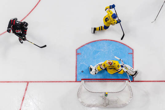 Brennan Othmann of Canada scores the 5-1 goal behind