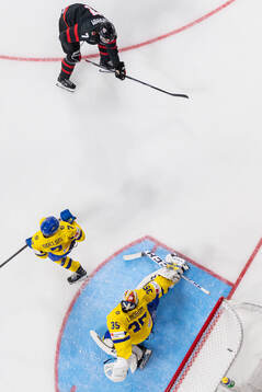 Brennan Othmann of Canada scores the 4-1 goal behind Calle