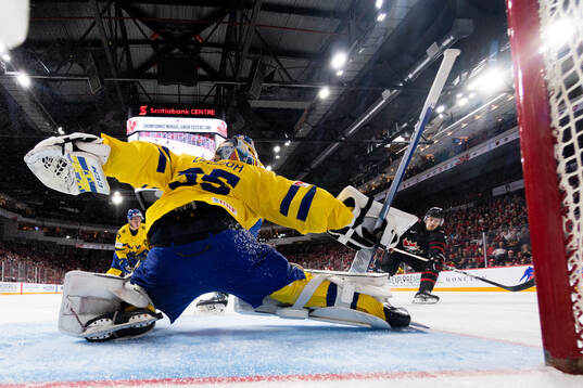 Brennan Othmann of Canada scores the 4-1 goal behind