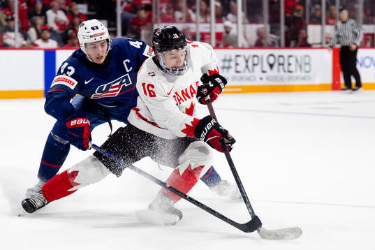 Luke Hughes of USA and Connor Bedard of Canada