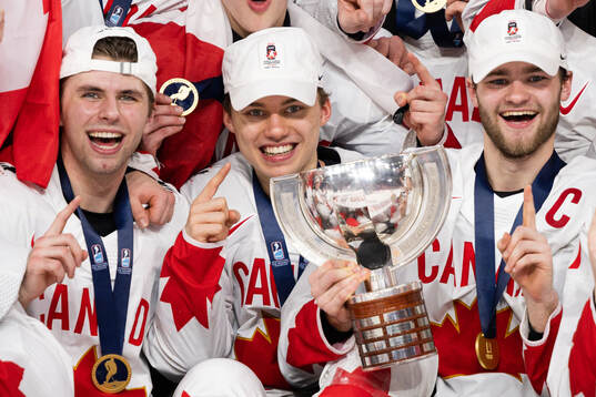Connor Bedard and Shane Wright of Canada celebrate with the