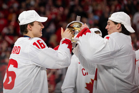Connor Bedard and goalkeeper Thomas Milic of Canada
