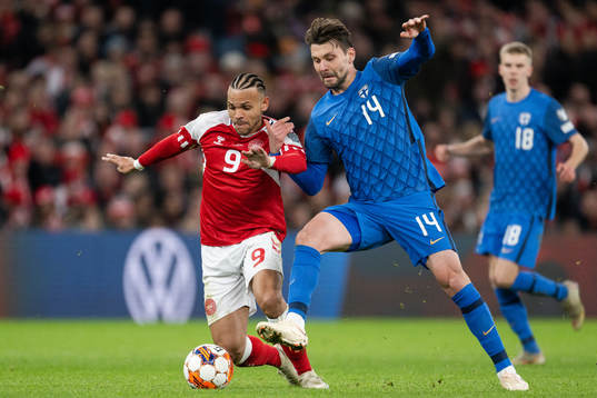 Martin Braithwaite of Denmark and Kaan Kairinen of Finland
