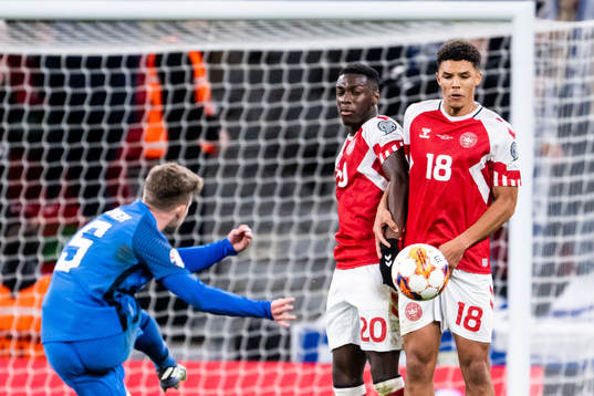 Arttu Hoskonen of Finland with a free kick against Mohamed Daramy and Alexander Bah of Denmark