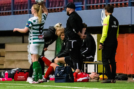 Robyn Virginia McCarthy of Grand Bodø leaves the pitch with an injury