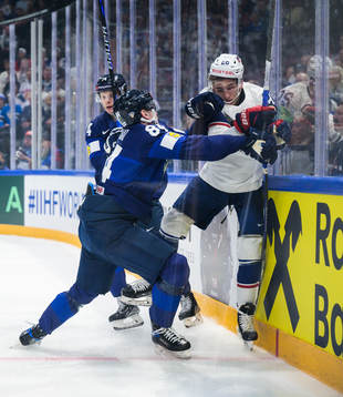 Kaapo Kakko of Finland tackles Lane Hutson of USA