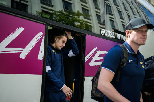 Leo Carlsson and goaltender Lars Johansson of Sweden leave