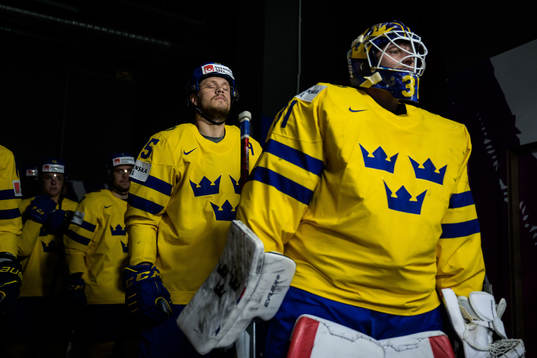 Jacob de la Rose and goaltender Lars Johansson of Sweden