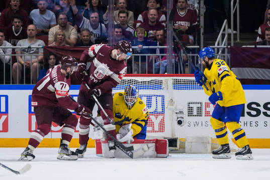 Roberts Bukarts and Oskars Batna of Latvia next to