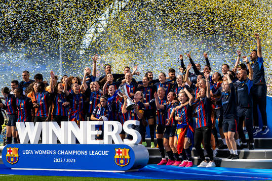 Players of Barcelona celebrate with the trophy