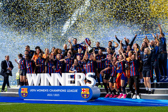 Players of Barcelona celebrate with the trophy