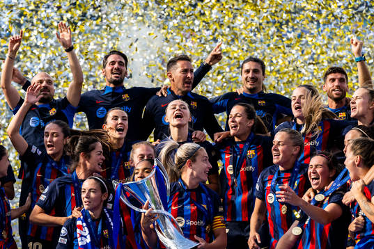 Players of Barcelona celebrate with the trophy
